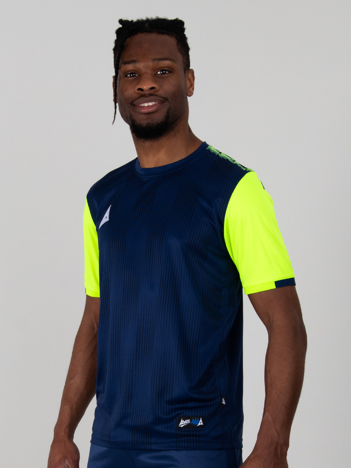 model wearing a navy blue and yellow / volt sports football training t-shirt.