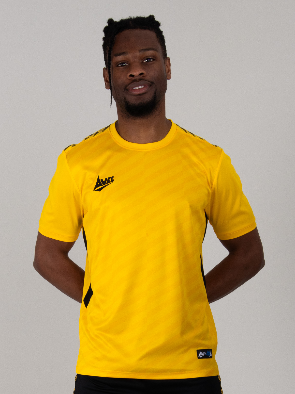 a man is wearing a two-tone yellow football shirt with black details and panels.