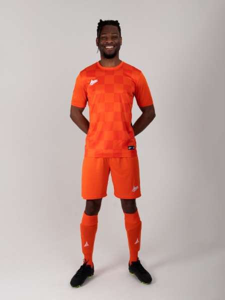 A full orange football kit with black details