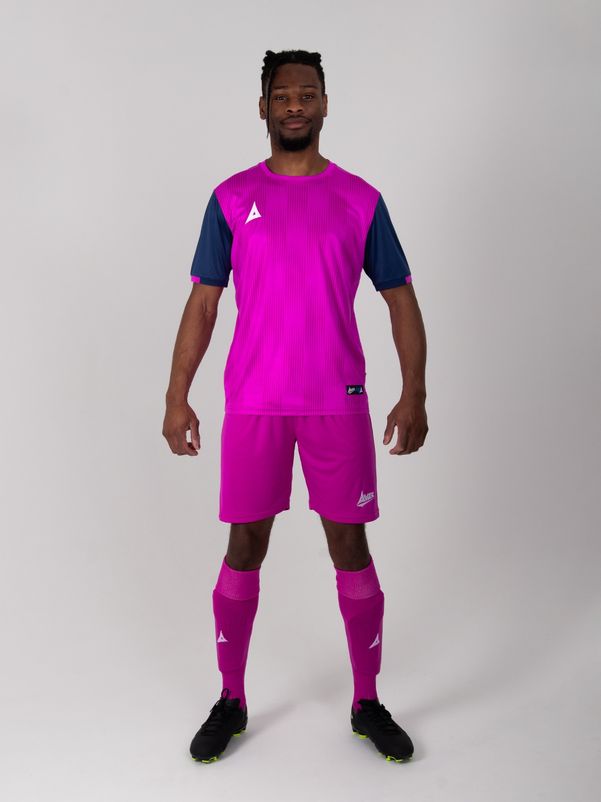 a full purple football kit with navy sleeves.