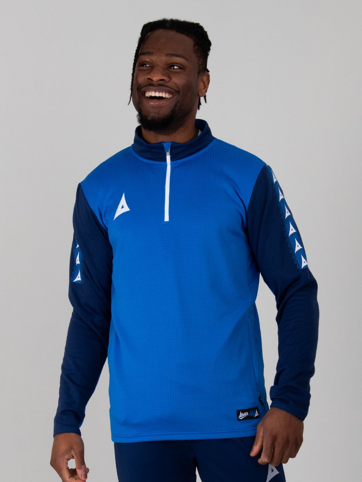this royal blue and navy jumper is being worn by a man. the jumper has a white quarter zip design and navy funnel neck
