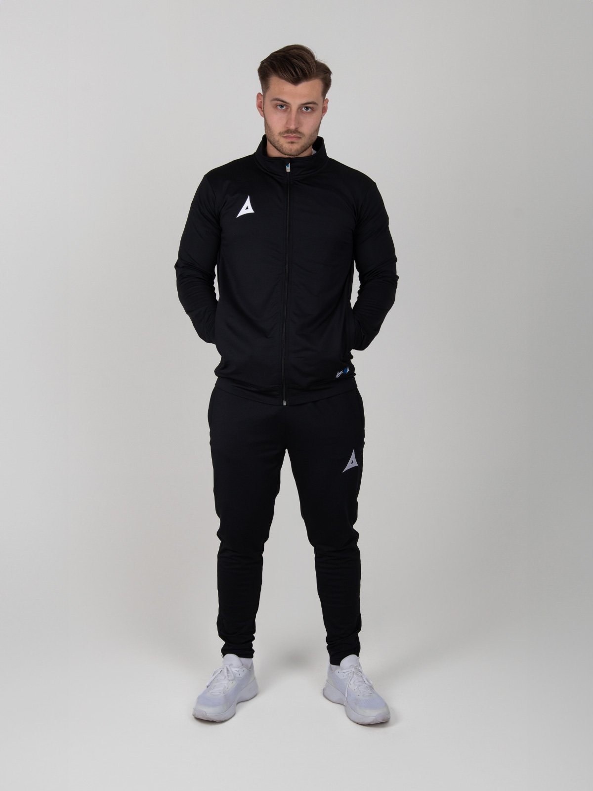 a man is wearing a full plain black tracksuit