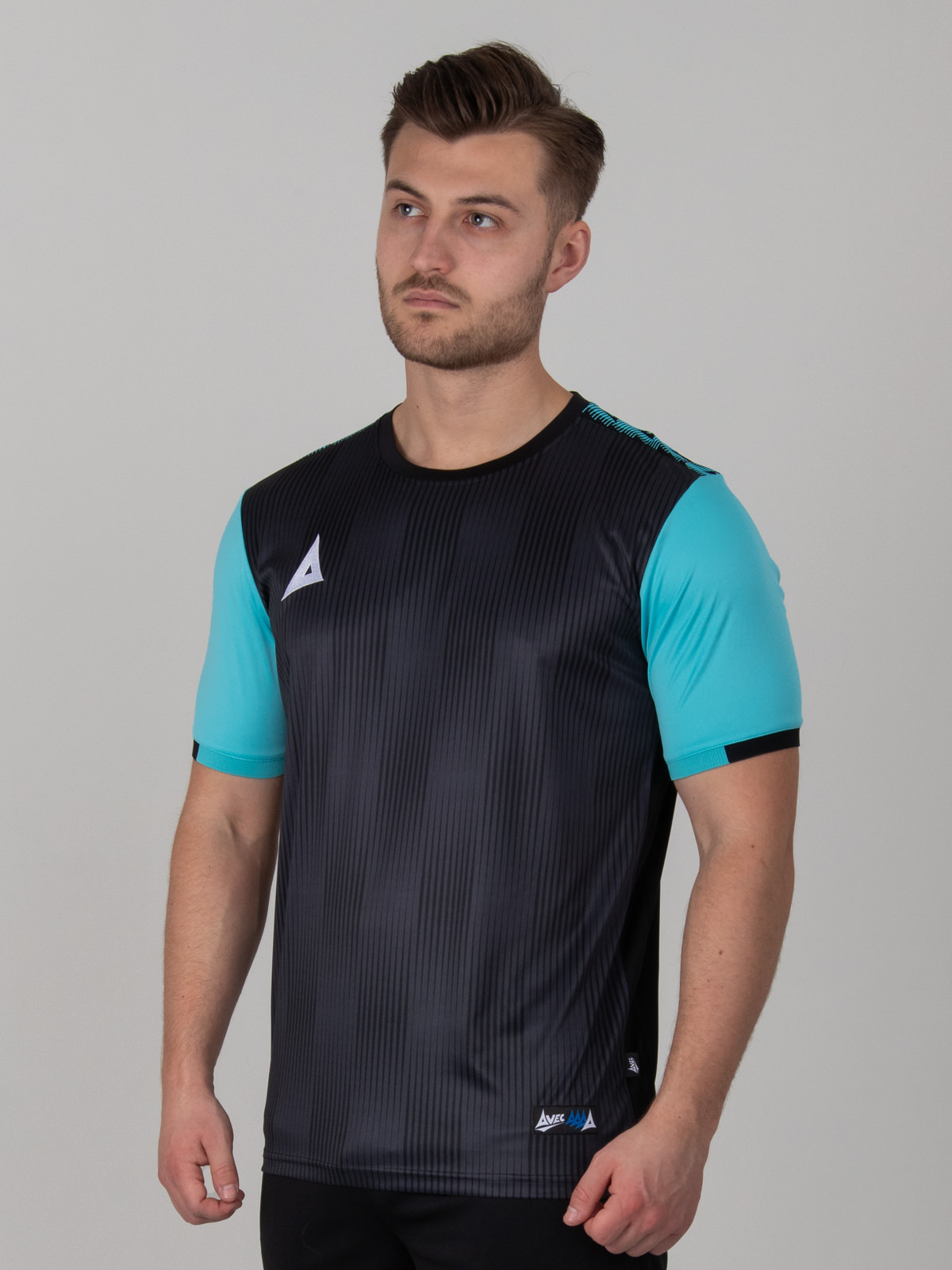 a black football shirt with a two-tone black graphic print design and light blue sleeves