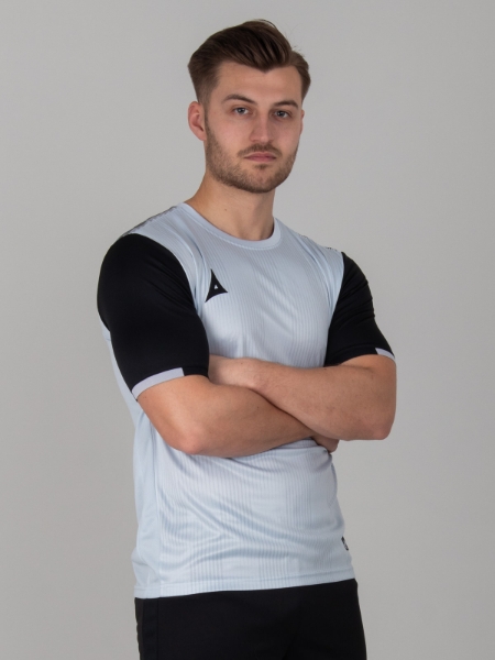 A man is wearing a grey football shirt with a graphic print design and black sleeves