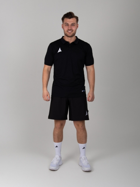 Styled man wearing a Black Polo Shirt with Black tech short and grip socks