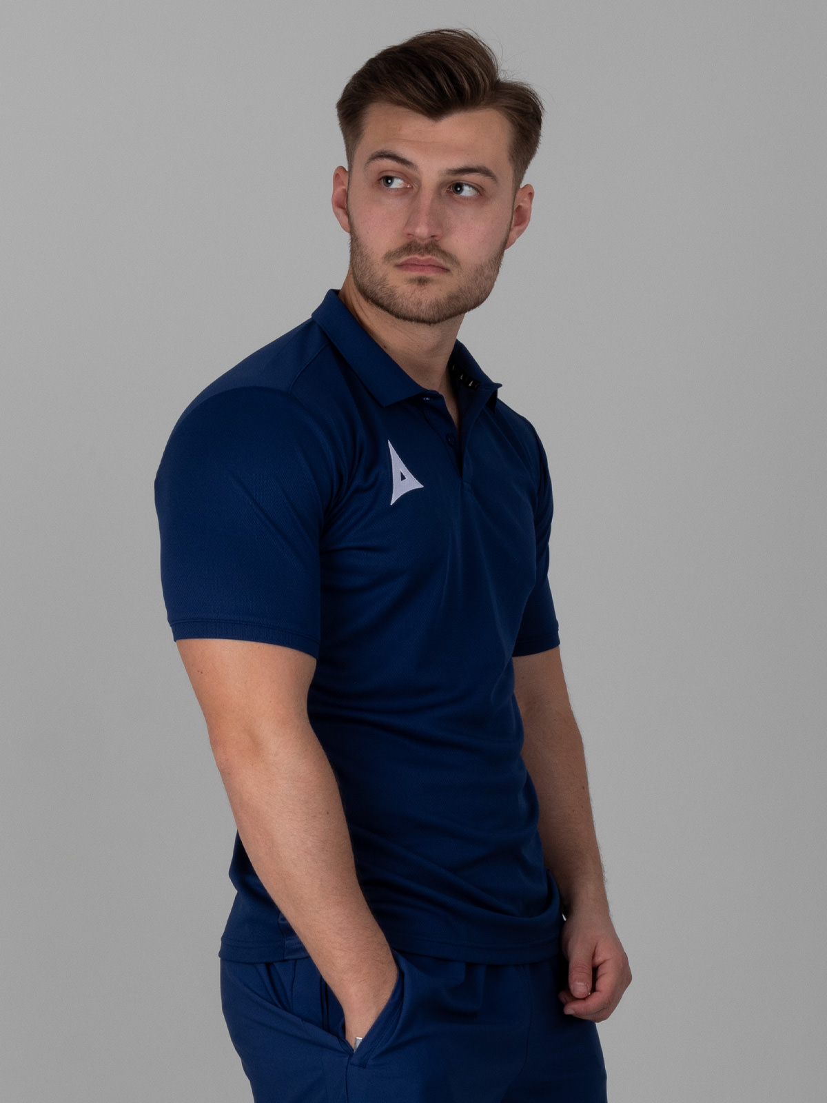 a man is wearing a smart navy polo shirt