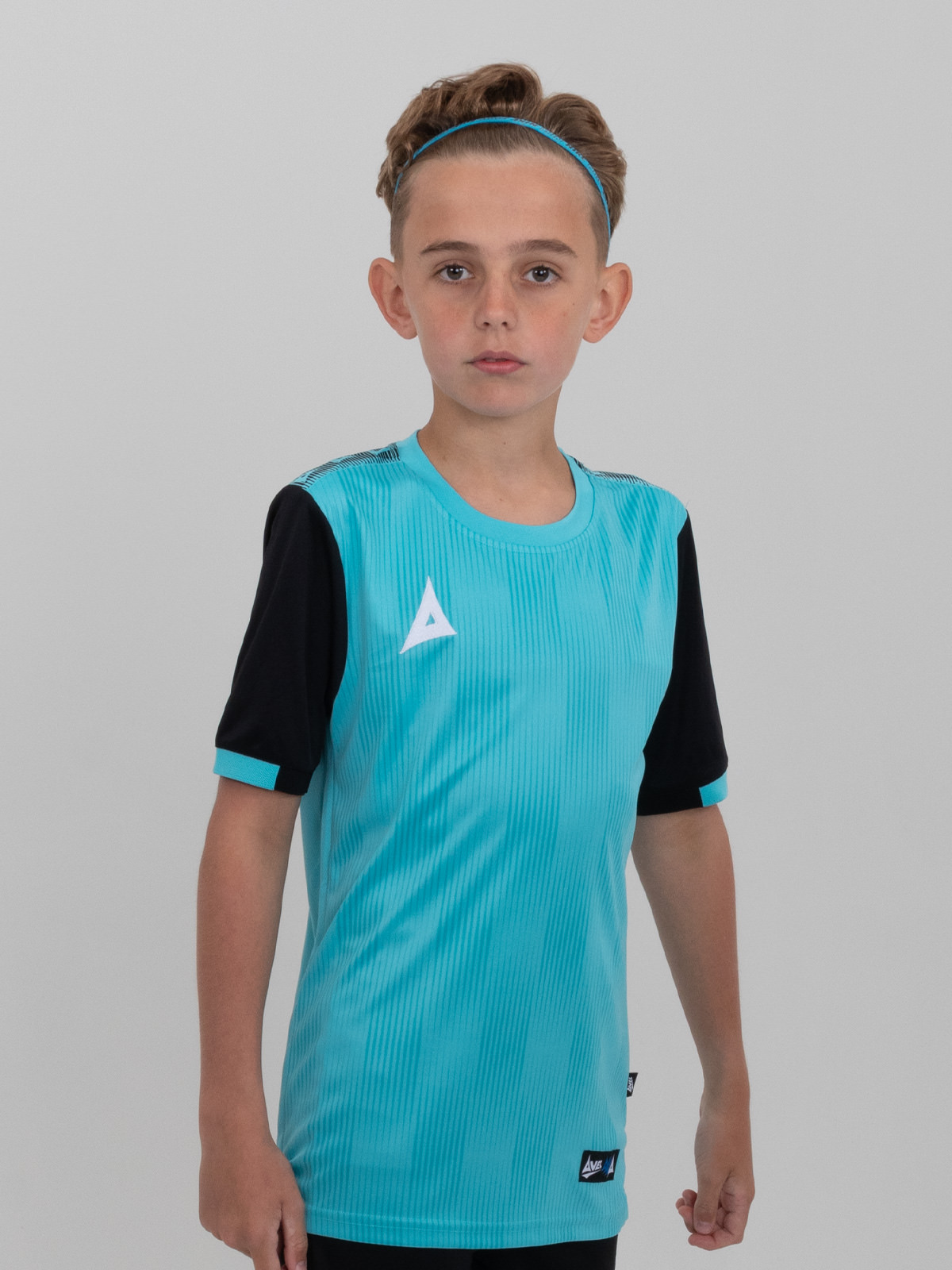 a young child wearing a junior light blue football shirt with black sleeves
