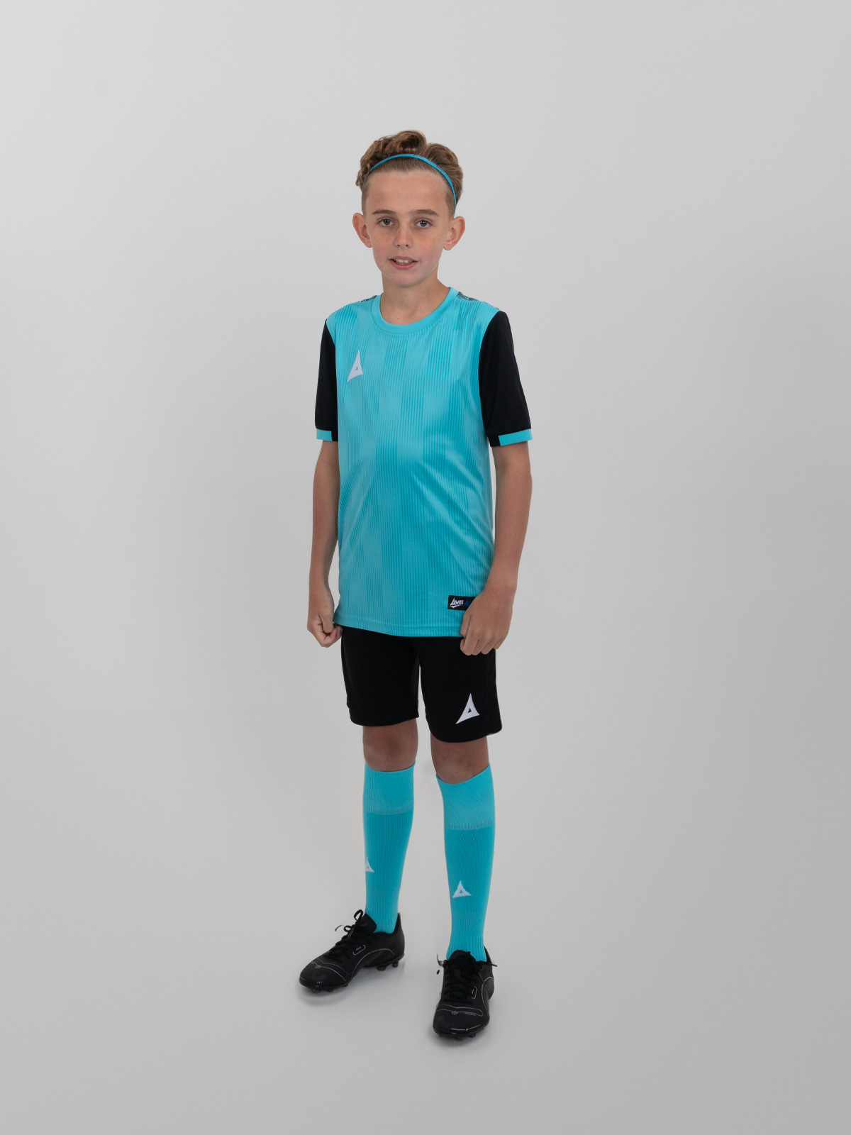 a child wearing a junior football kit which is light blue and black