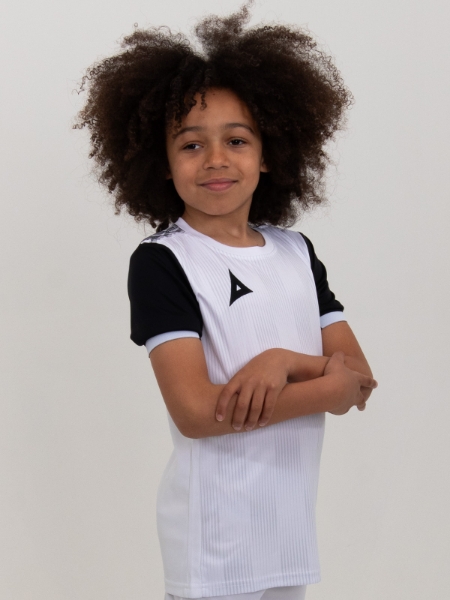 A junior footballer is wearing a children's white football shirt with black sleeves