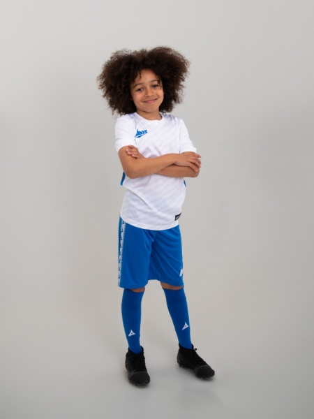 A young child is wearing a white and blue football kit