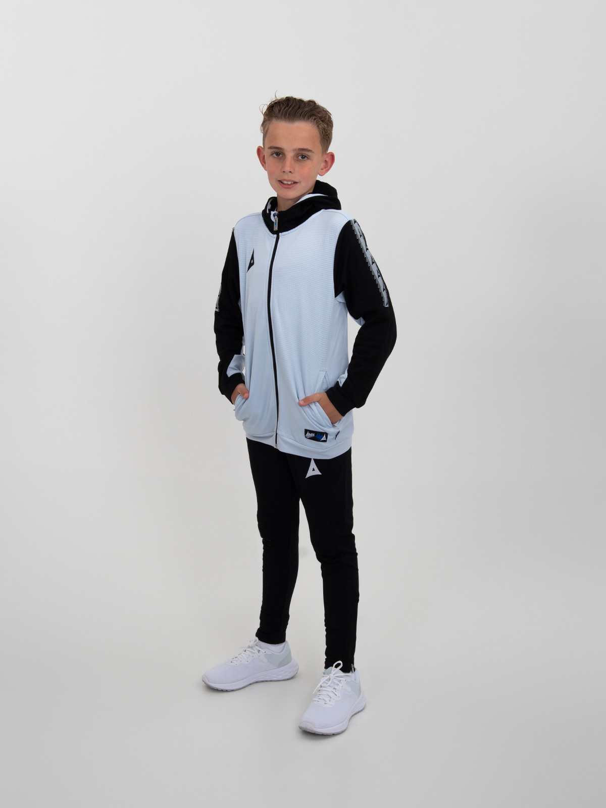 a children's hoody is worn with with black joggers