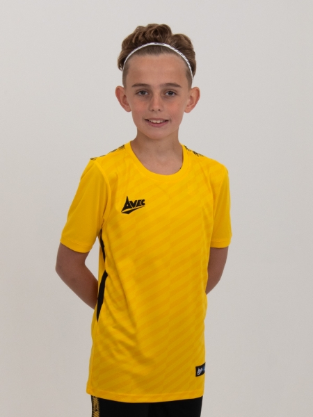 A child is wearing a yellow football shirt with black trim. It features a tonal graphic print on the front. 