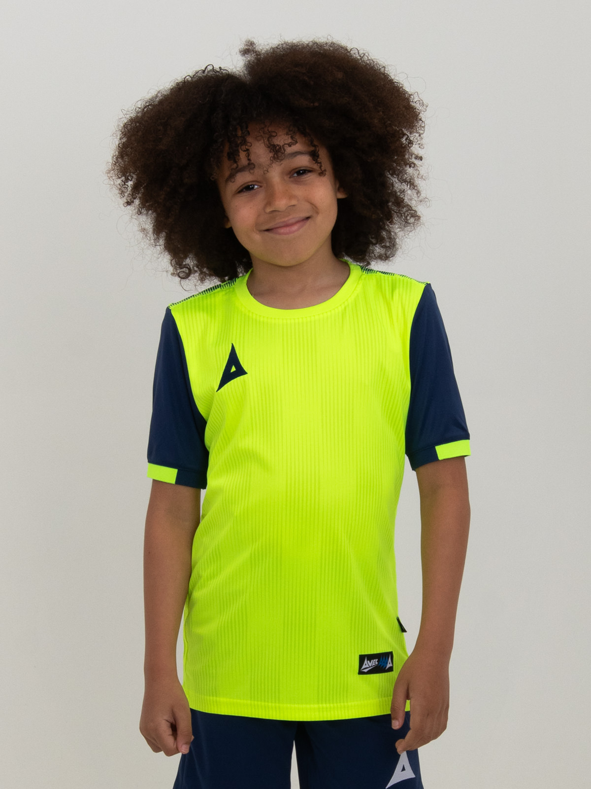 the child in the photo is wearing a neon yellow football shirt with navy sleeves.