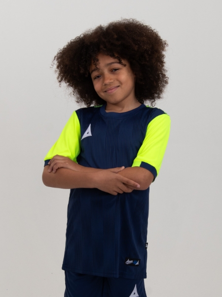 A young child is wearing a Navy Football Shirt with Neon Yellow sleeves. The football shirt has a two-tone graphic