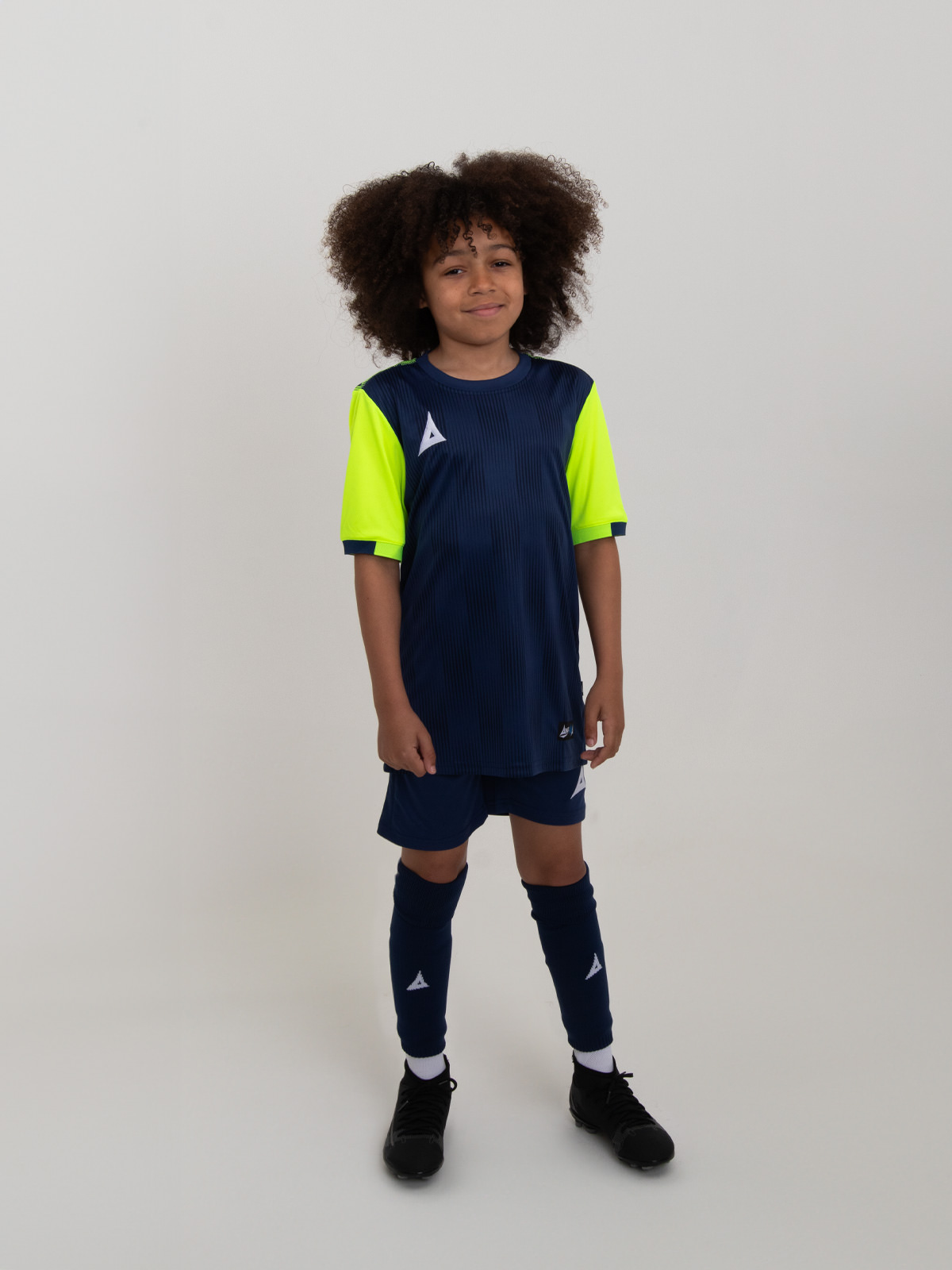 a kids football kit in navy blue with yellow sleeves