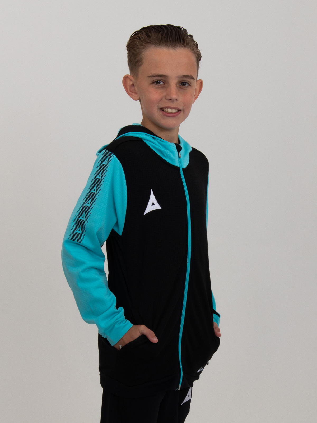 a kids black hoody with pale blue sleeves and hood is being worn by a child.