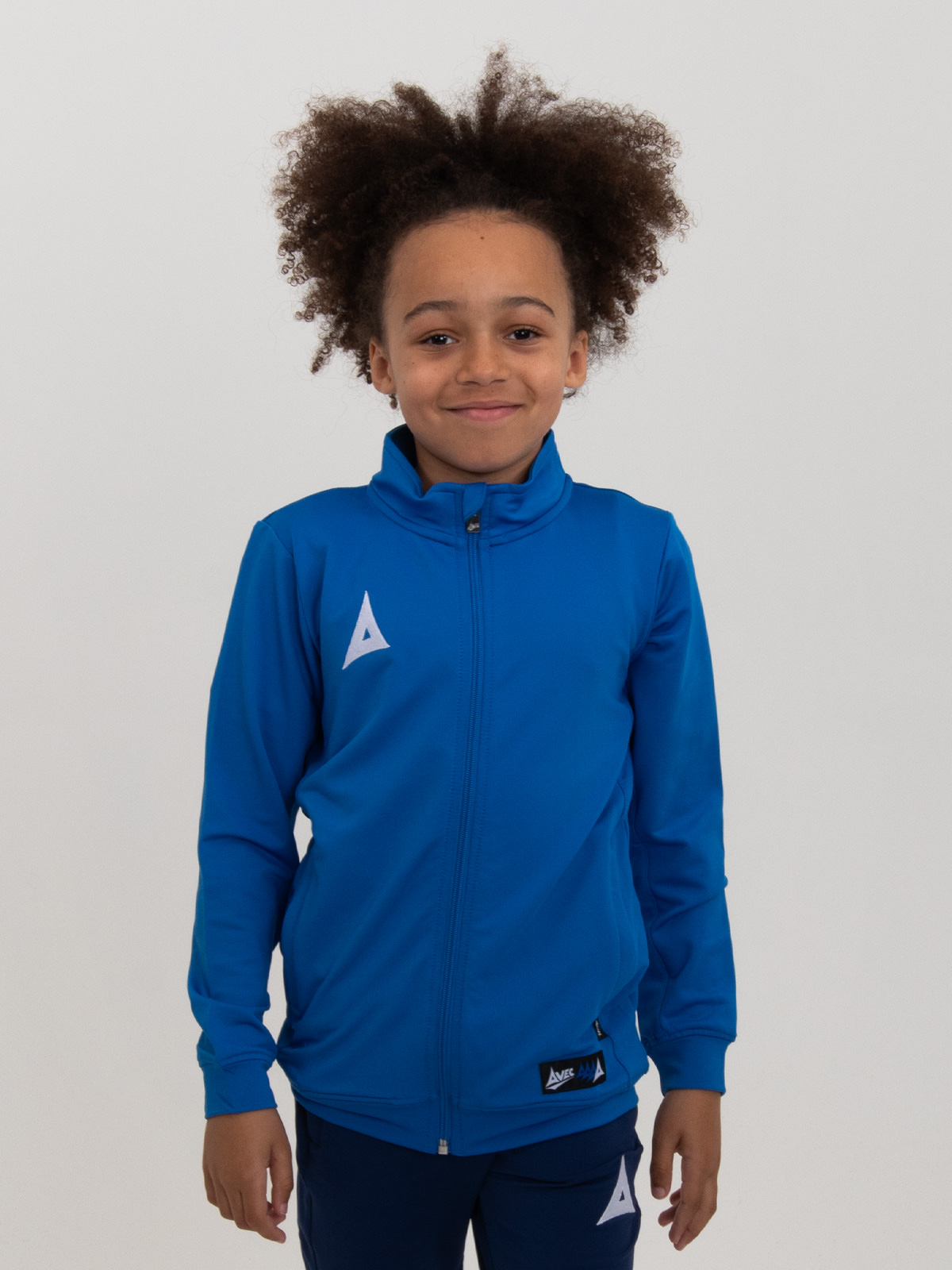 a child is wearing a junior royal blue tracksuit jacket