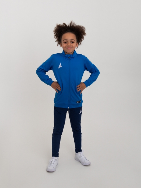 A junior is wearing a childrens tracksuit in royal blue and navy
