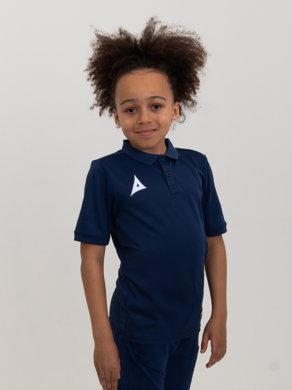 a kids polo shirt in navy blue helps juniors look smart for presentation nights and travel between games.