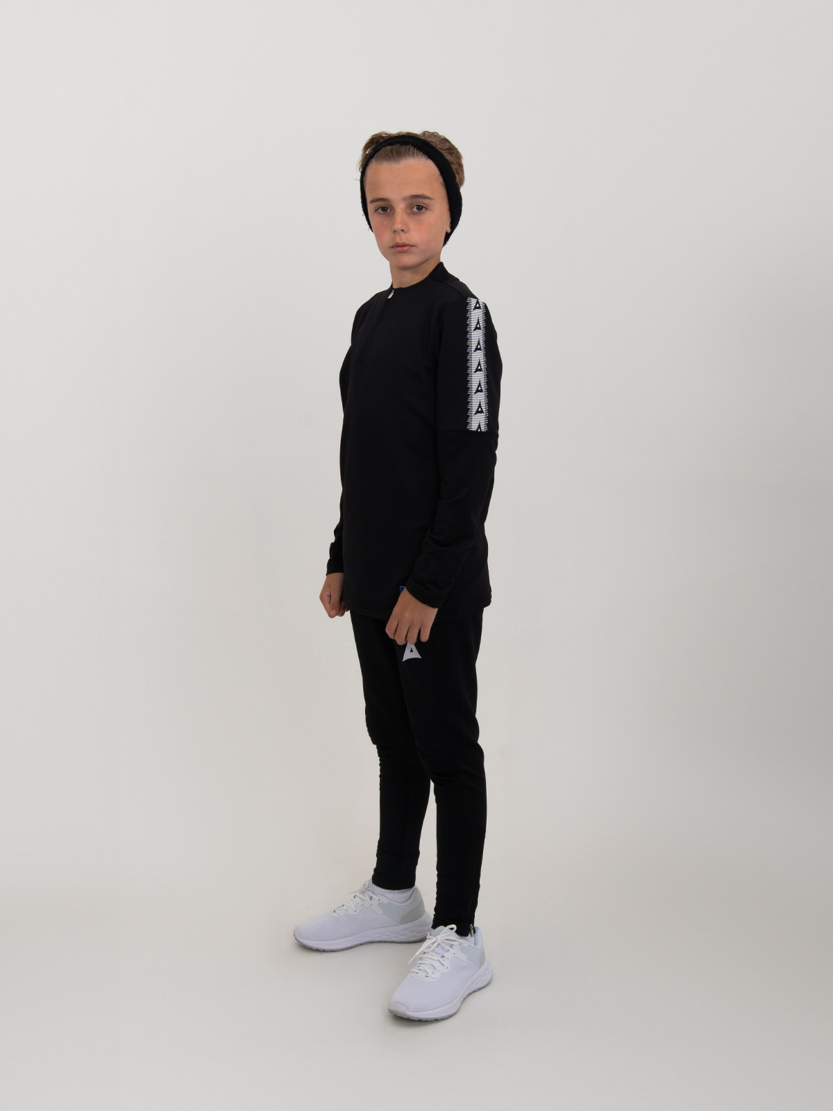 a side on image of our childrens black jumper being worn by a boy