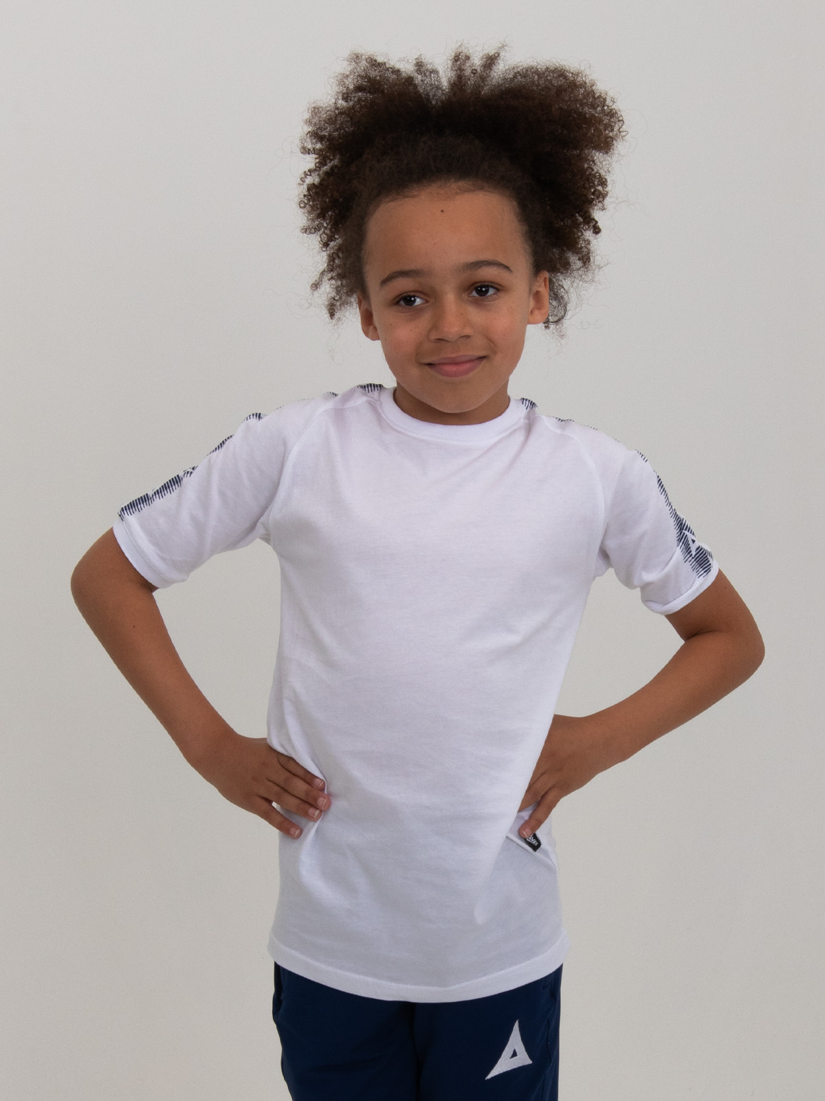 this classic kids white cotton t-shirt is being worn by a young boy