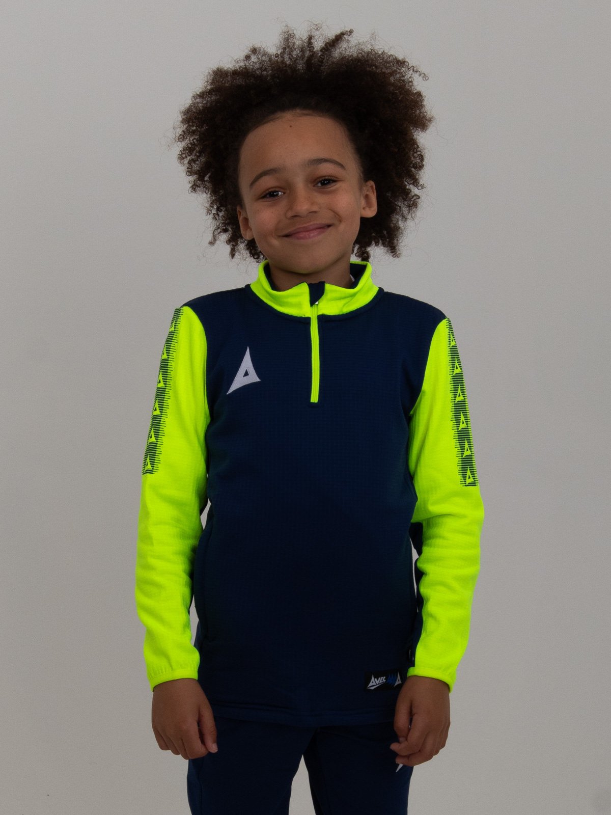 a kids navy blue jumper with yellow sleeves makes this young boy stand out from the crowd.