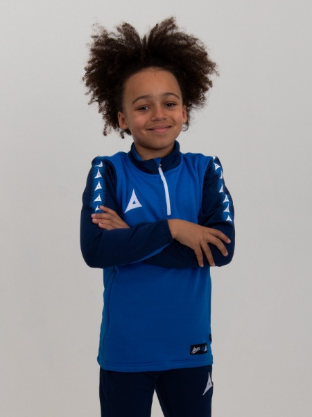 With his arms folded, this young boy is wearing a soft and comfortable royal blue and navy jumper with a zip.