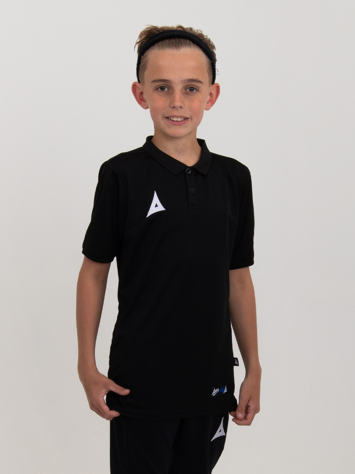 a junior is modelling a kids black polo shirt