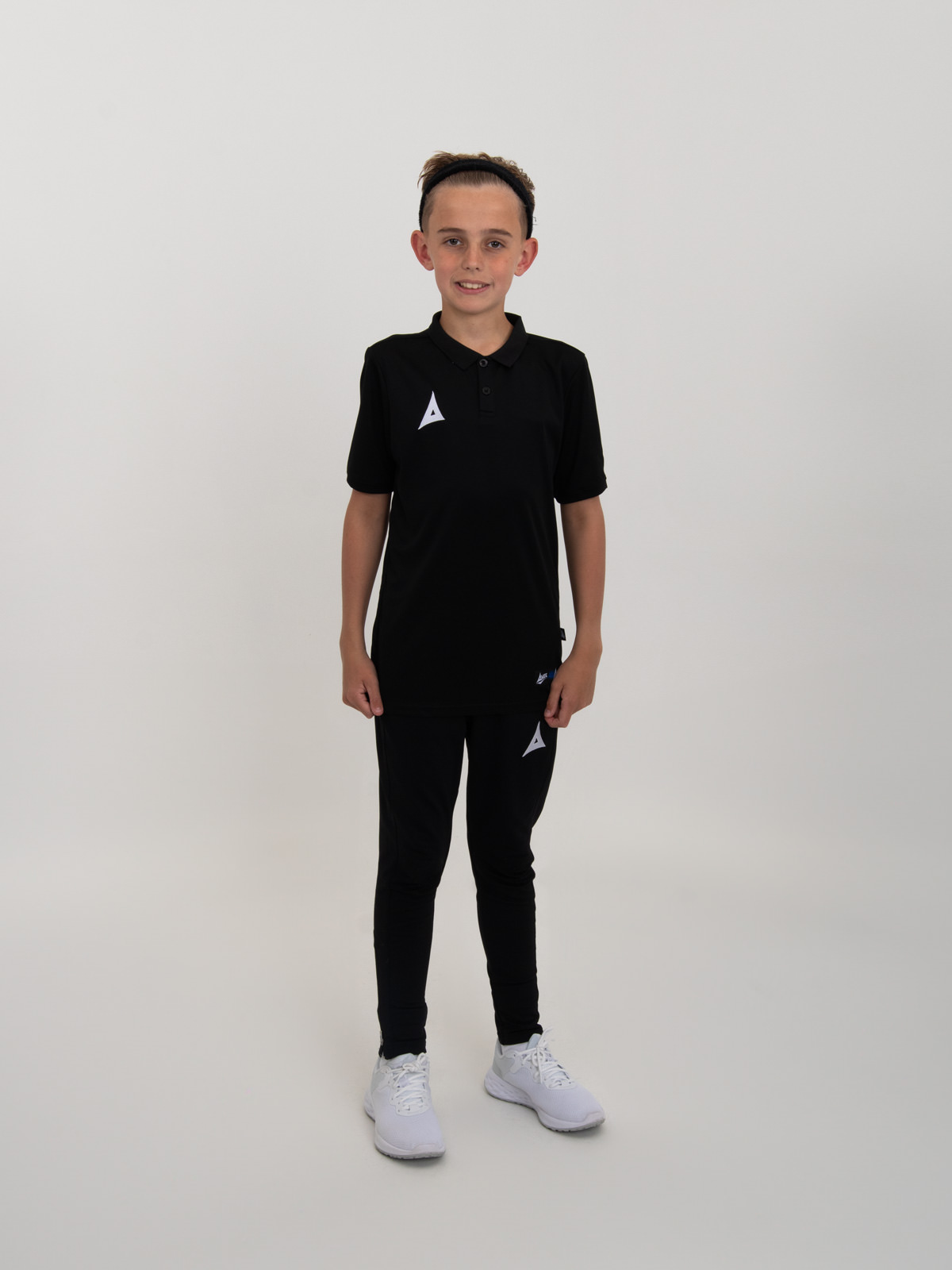 looking smart, this child is wearing a plain black polo shirt with black jogging bottoms