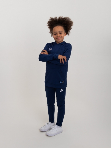 A kid is standing in a childrens blue hoody and matching tracksuit bottoms
