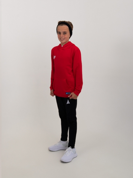 A boys red hoody is being worn with black joggers