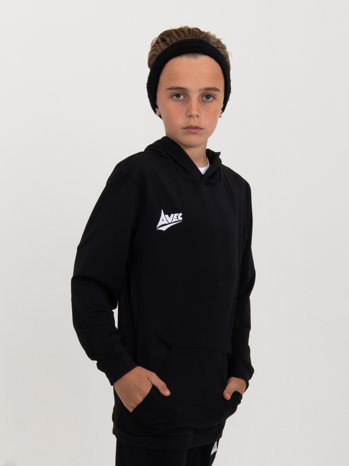 a boy is wearing a plain black hoody with a pouch