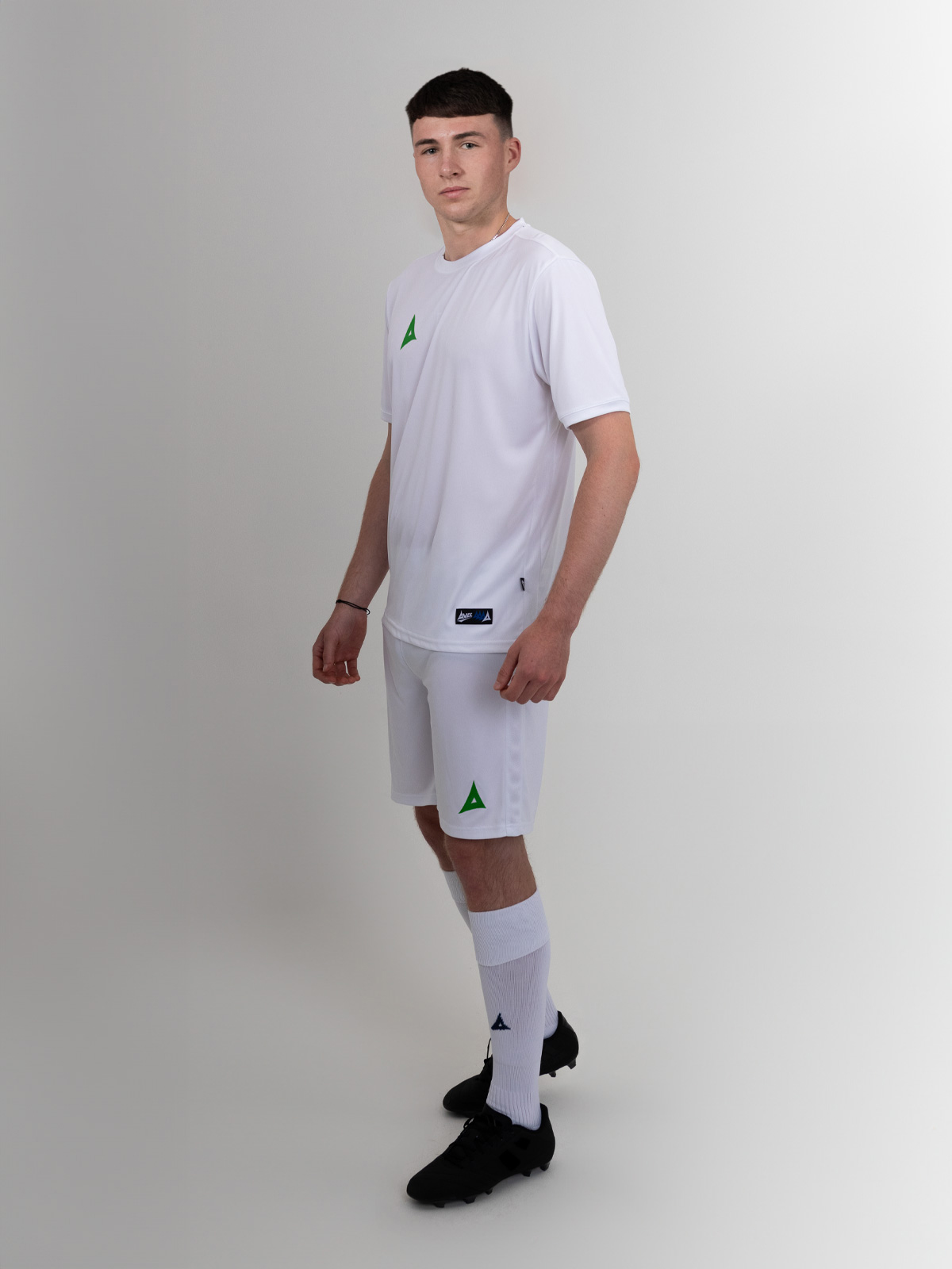 the man in the image is wearing white shorts with a green logo