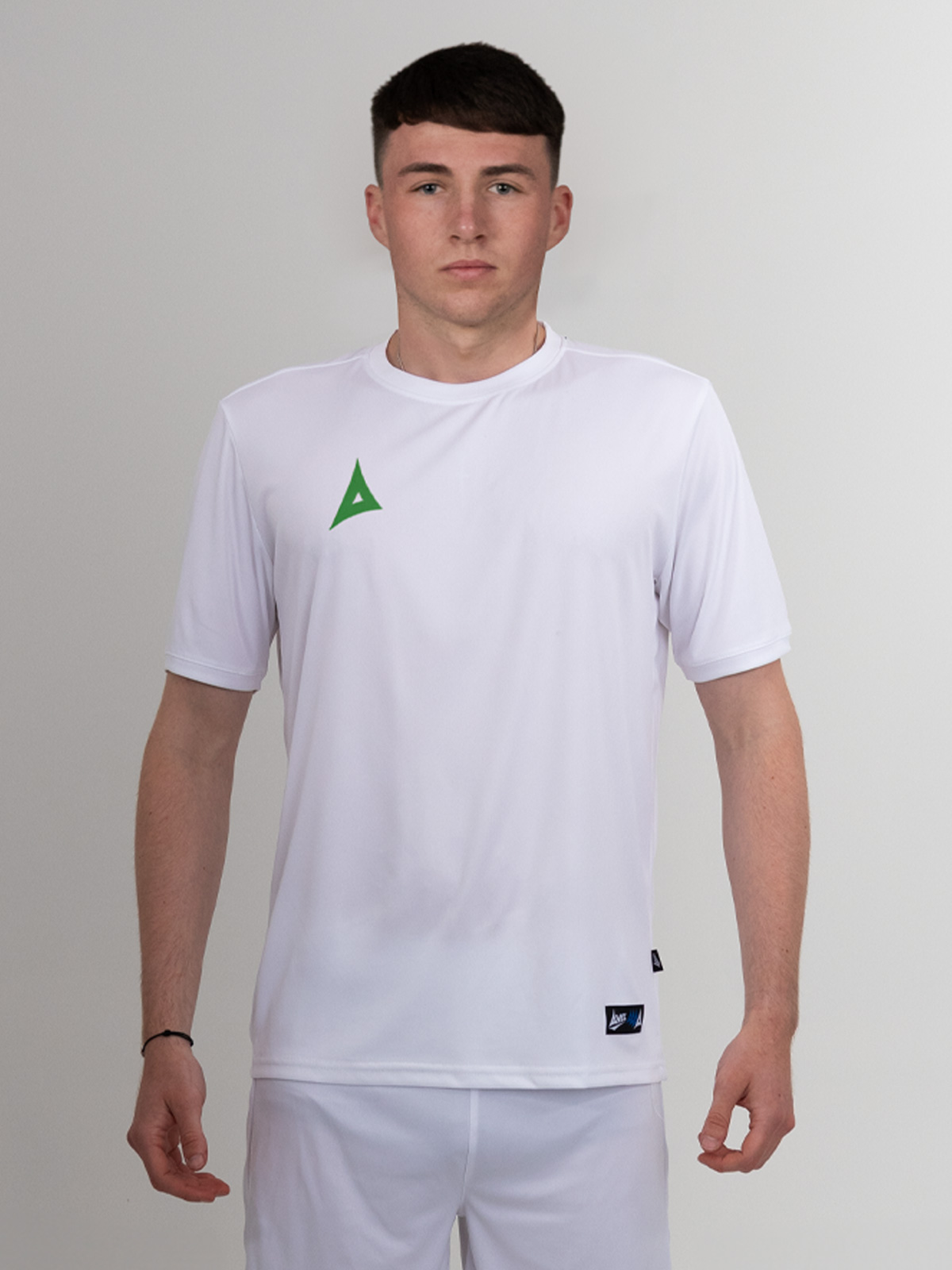 a white shirt with a green logo can be worn with white or green shorts