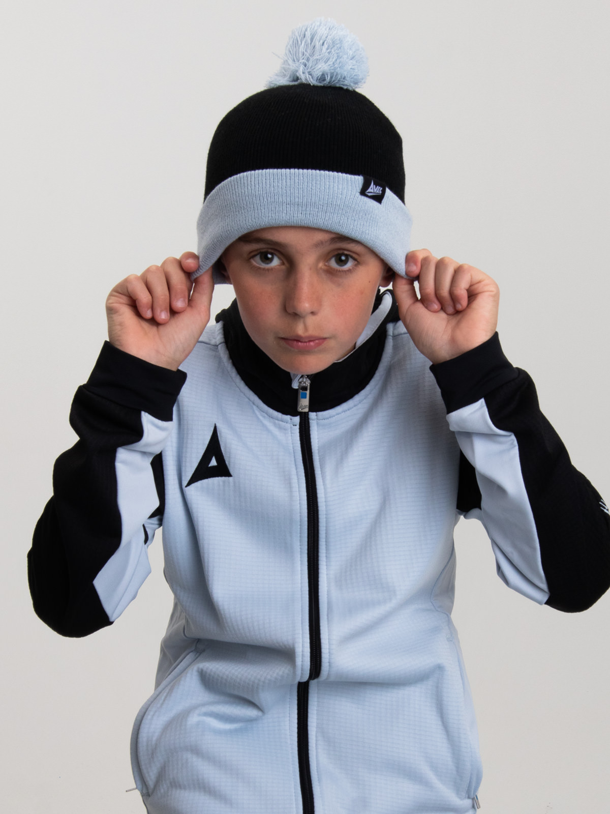 a child is wearing a junior beanie hat in black and grey.