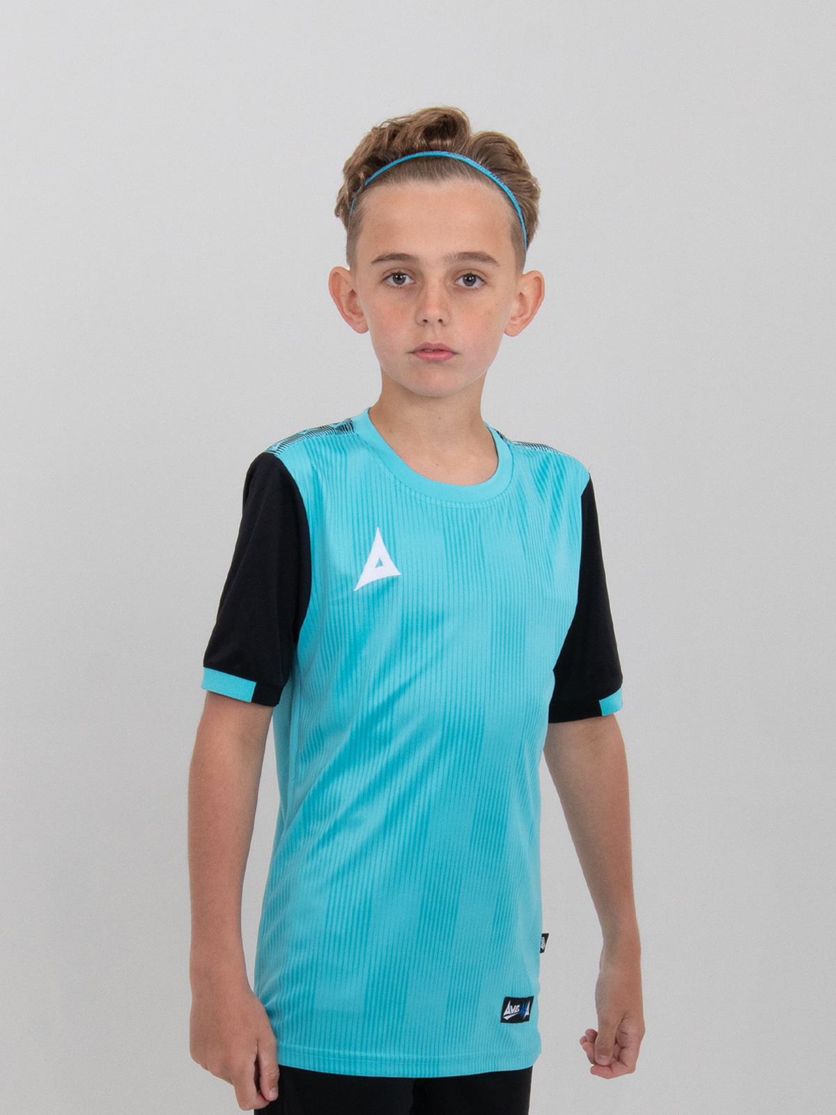 a young child wearing a junior light blue football shirt with black sleeves