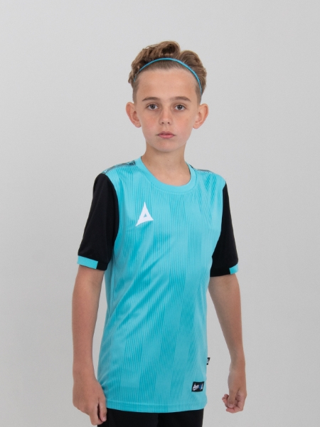 A young child wearing a junior light blue football shirt with black sleeves