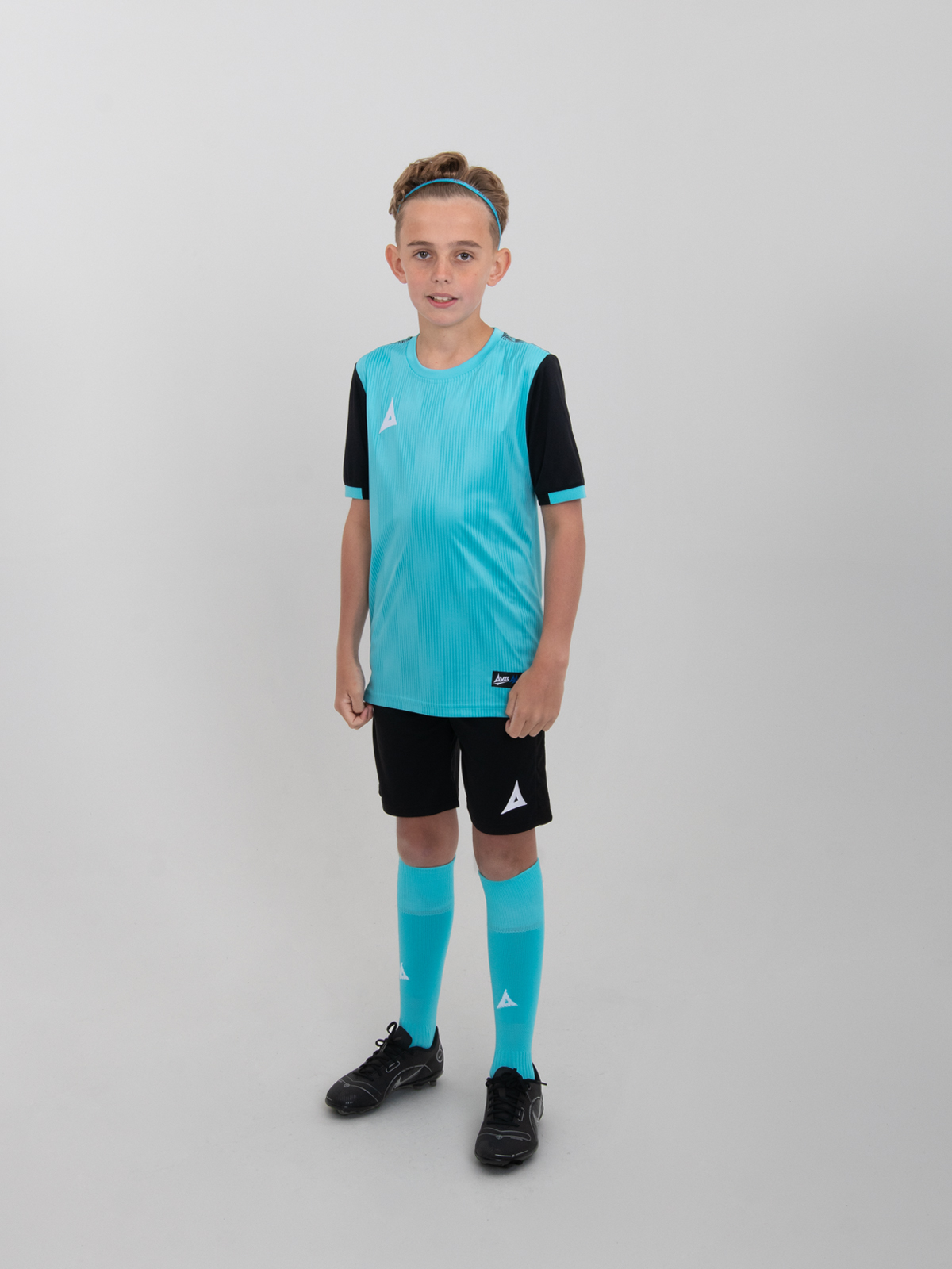 a child wearing a junior football kit which is light blue and black