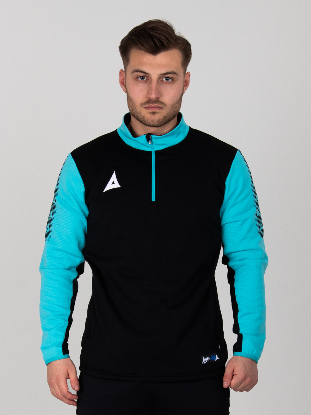 a man is wearing a black and light blue jumper which has a quarter-zip