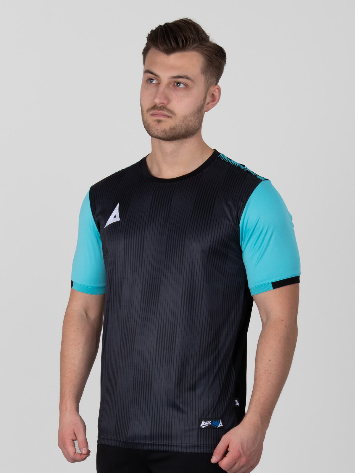 a black football shirt with a two-tone black graphic print design and light blue sleeves