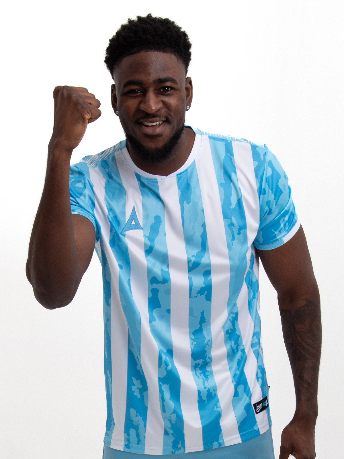 an adult is wearing a sky blue and white stripe shirt, which resembles the likes of the argentina national team. there is a camo pattern within the sky blue elements