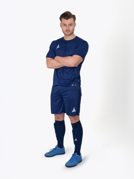 A man wearing an all Navy Blue Football Kit