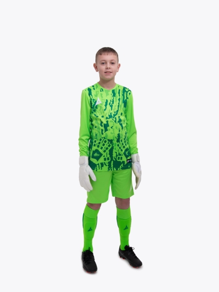 A kid standing up wearing a neon green goalkeeper football shirt, matching Shorts and Football Socks.