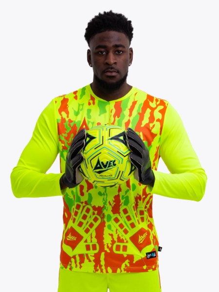 Man is wearing a neon yellow goalkeeper football shirt with orange accents and a neon yellow football