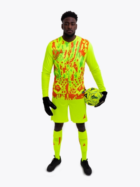 A model is wearing a full neon yellow goalkeeper football kit and holding a neon yellow football matching the kit