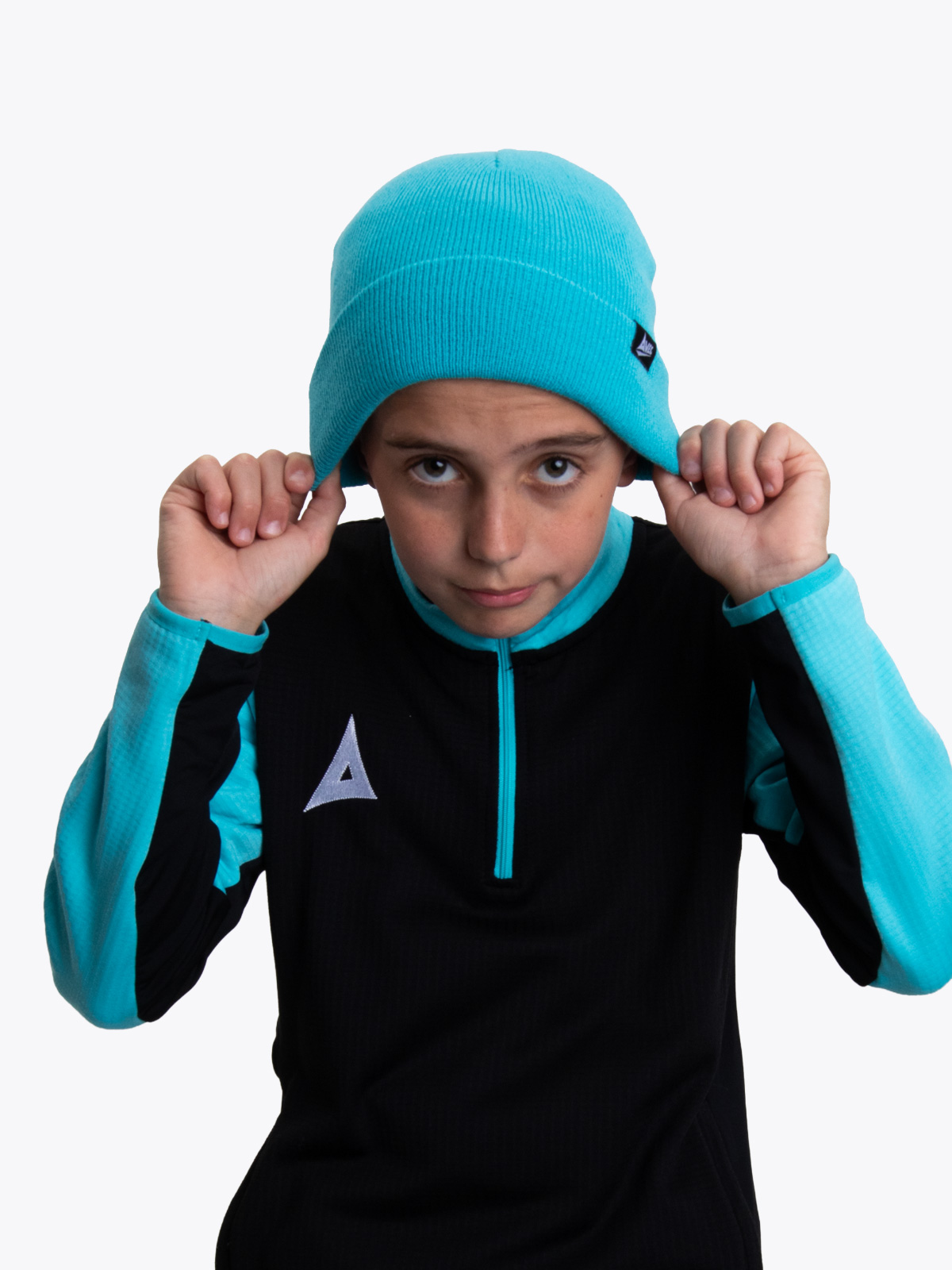 this boy is keeping warm with the blue turn up hat