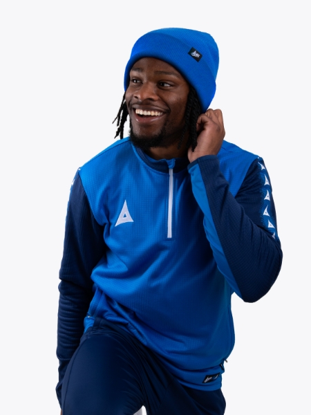 A man keeping warm wearing a royal blue turn up bronx beanie
