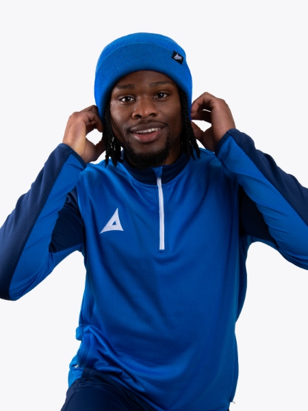 A man keeping warm wearing a royal blue turn up bronx beanie