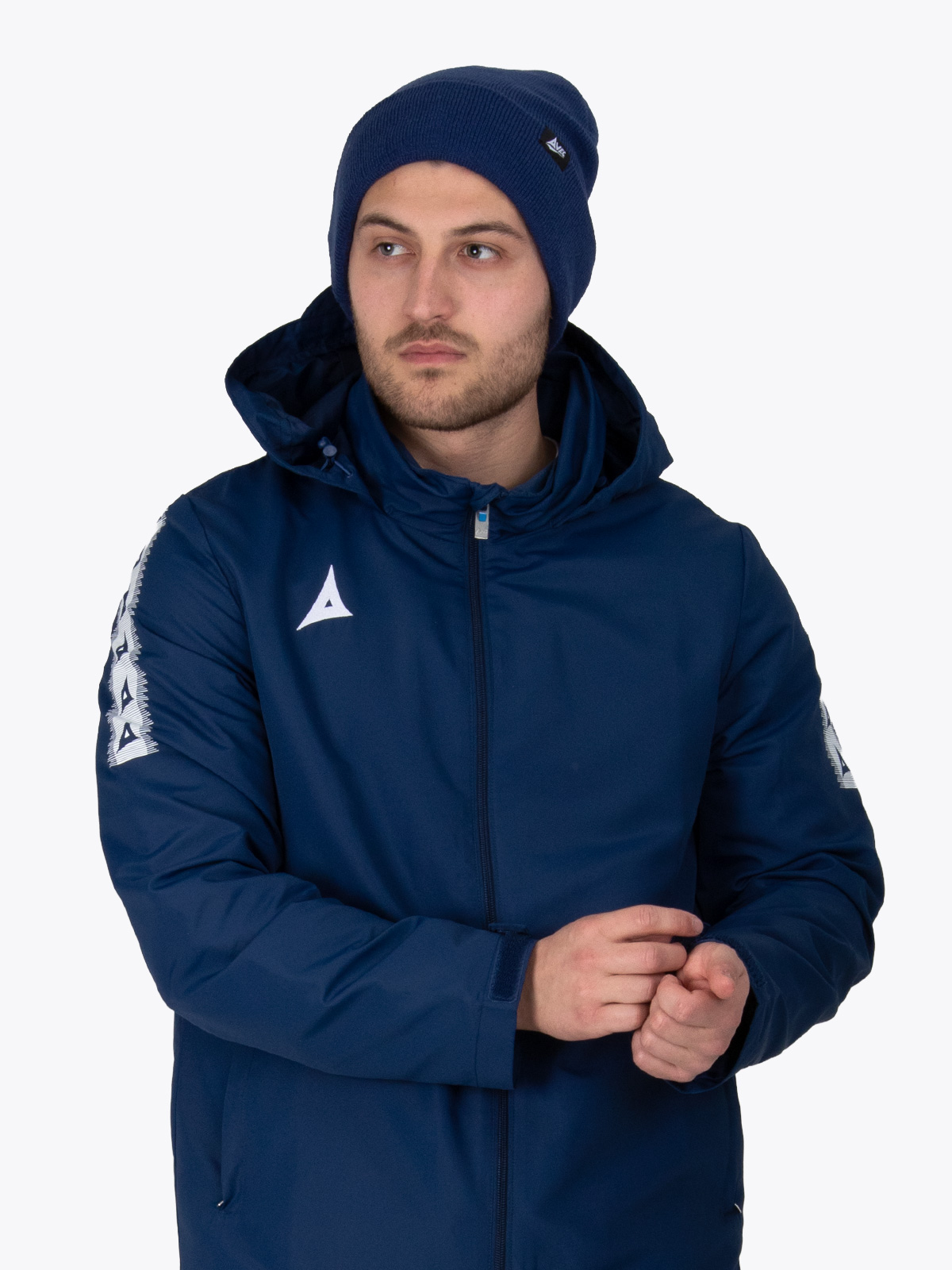 a man wearing a navy rain jacket and a matching navy turn up beanie