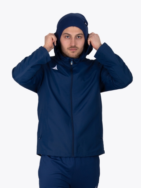 A man wearing a navy rain jacket and a matching navy turn up beanie putting his hood up